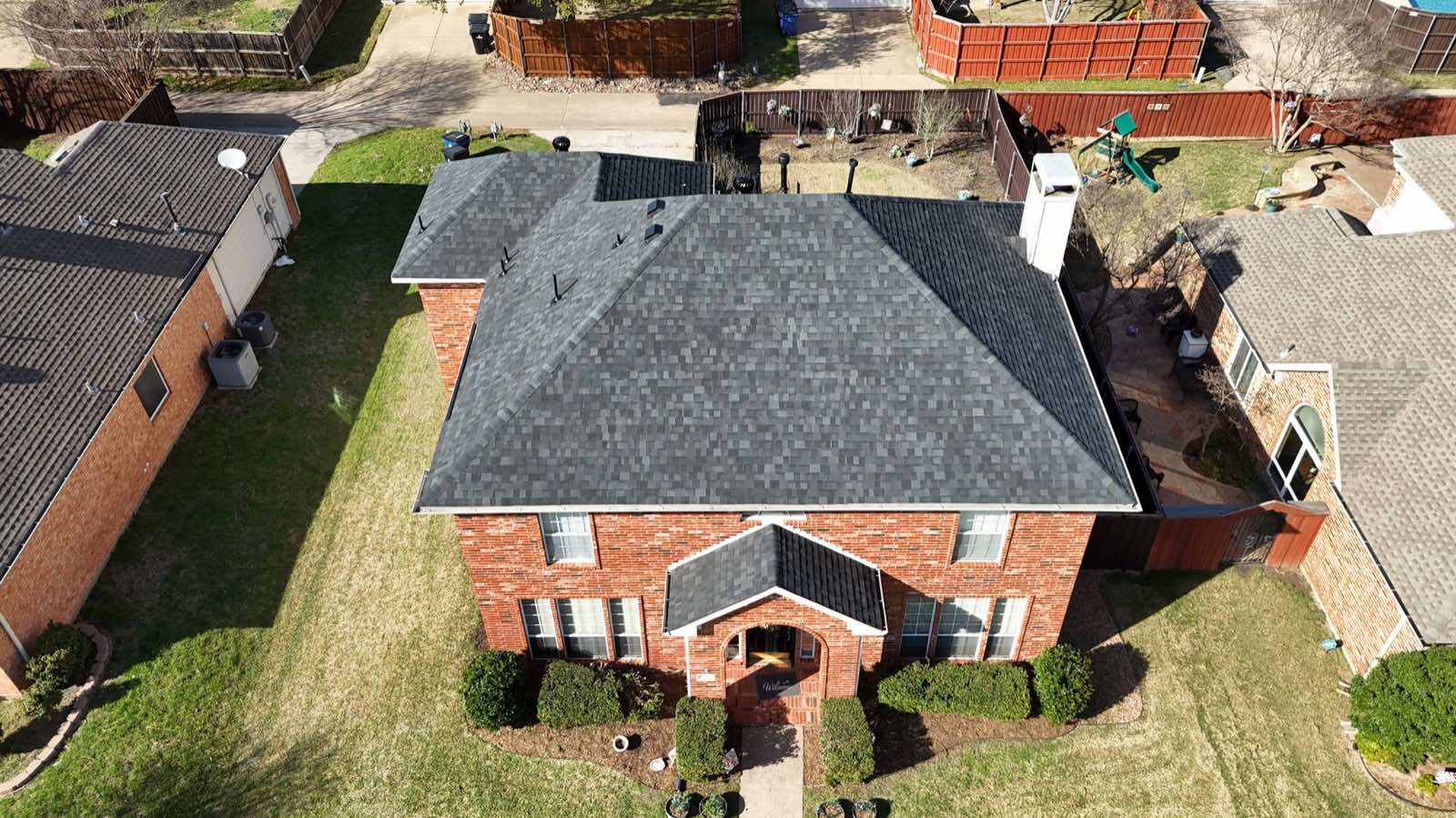 Aerial view of a new roof on a brick home