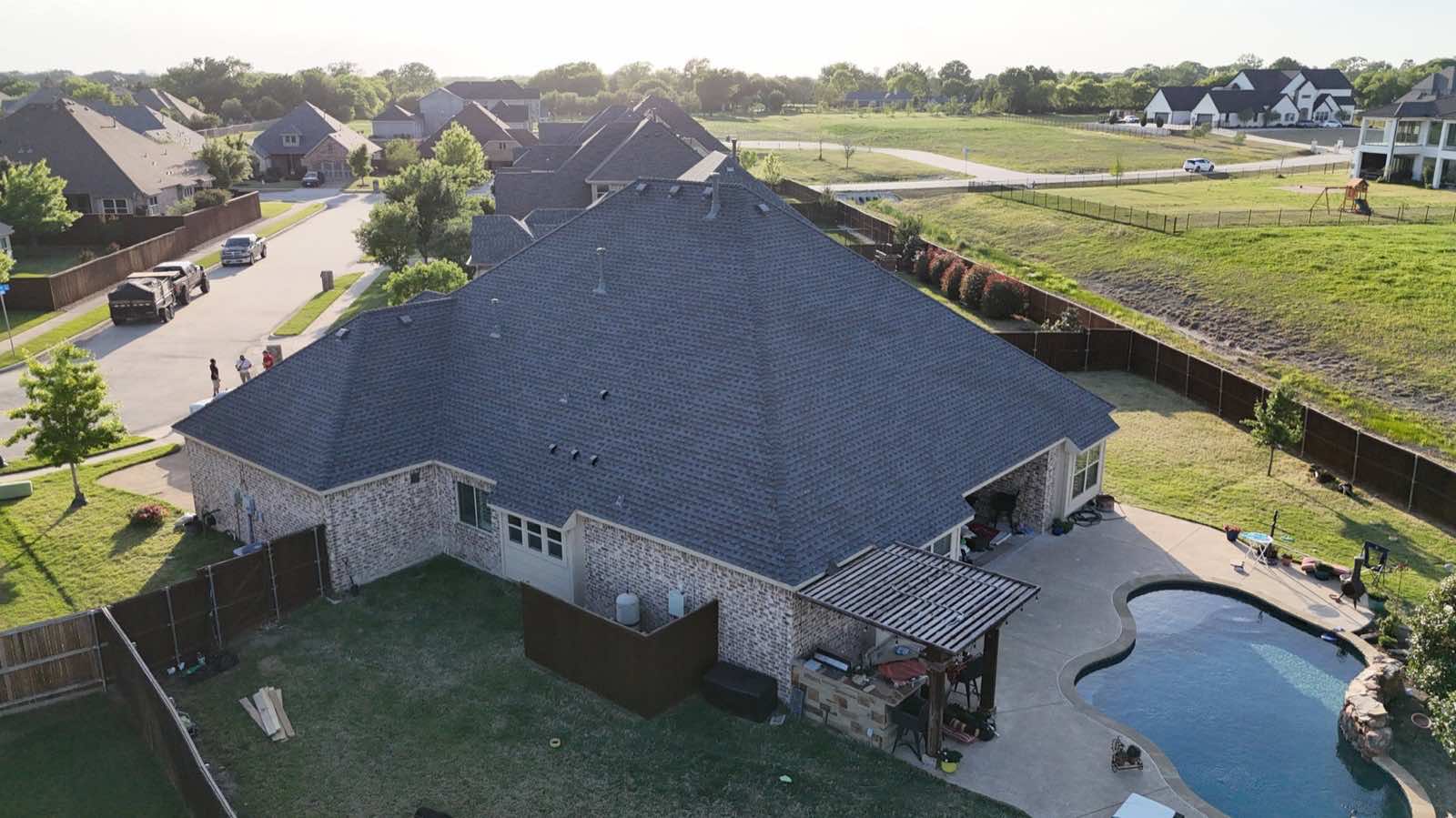 New roof on a large home at golden hour