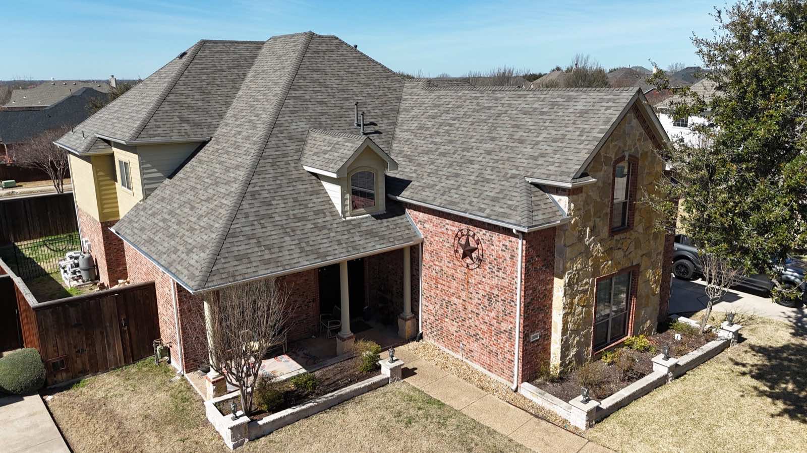 Two-story brick home with a new shingle roof